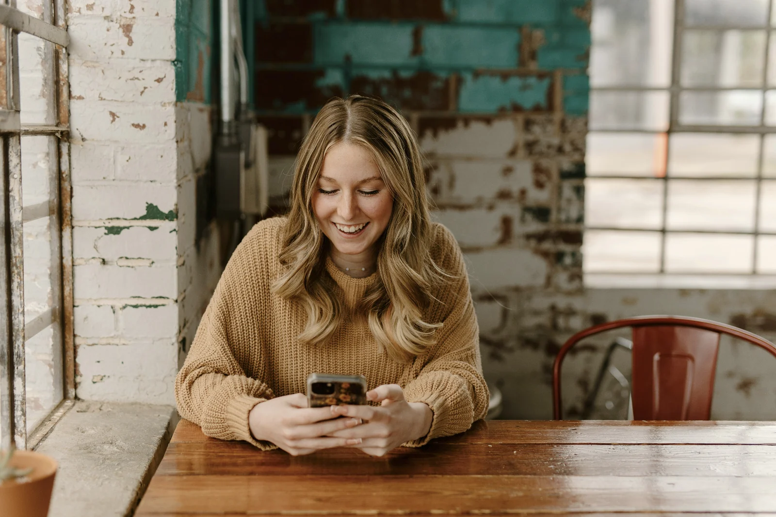 A woman using CitizenUp on her phone during a break