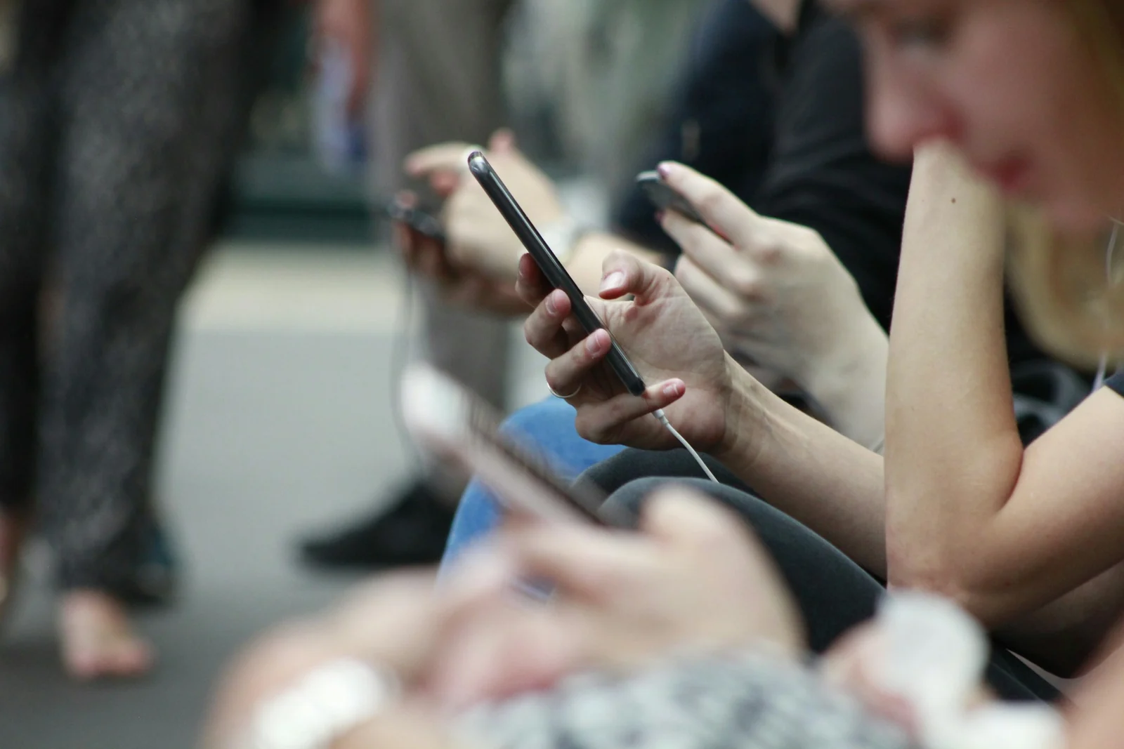 People using their phones while studying on the go